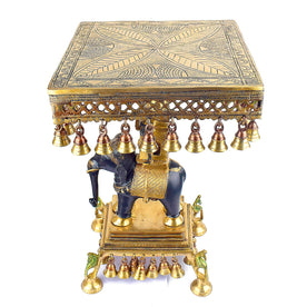  This 23 Inch Brass Chowki on Elephant with Hanging Bells is a stunning blend of artistry and tradition. Crafted from high-quality brass, the intricate detailing of the elephant and the delicately suspended bells add a touch of elegance to any space. 