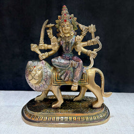  Embrace the powerful energy of Maa Durga with this 8.5-inch Brass 8-Armed Durga Idol, beautifully depicted riding her mighty lion. This meticulously crafted statue showcases Maa Durga in her most majestic form, symbolizing strength, courage, and divine protection. 