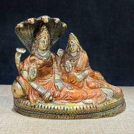  The 4.7 Inch Vishnu Ji Resting on Snake - Small Divine Figure is a beautifully crafted miniature statue that showcases Lord Vishnu in a serene and tranquil pose. Resting gracefully on the multi-headed serpent, Sheshnag, this divine figure symbolizes the eternal peace and protection Vishnu provides to the universe. 