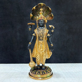  This elegant brass statue of Lord Vishnu seated on the mighty Seshnag is a powerful symbol of divine protection, balance, and cosmic order. The intricate craftsmanship beautifully depicts Lord Vishnu in his serene and majestic form, with the multi-headed Seshnag providing a protective canopy. 